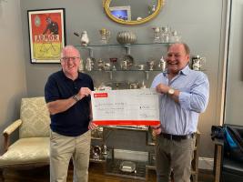 Ron Pringle presents a cheque for £20,000 to Club President Adrian Logan.